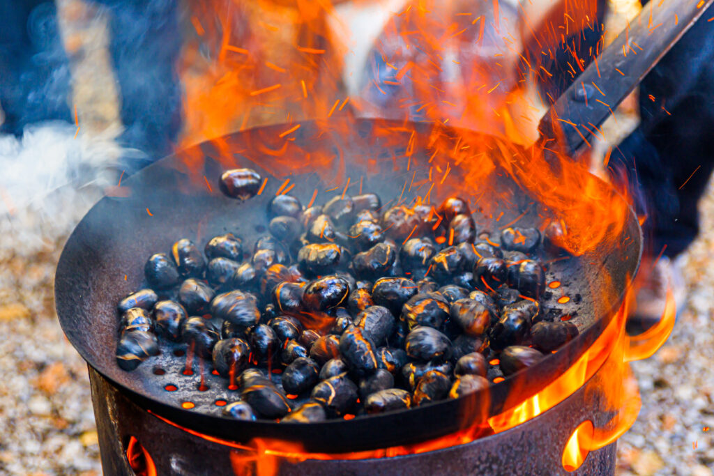 Chestnut or so-called Kerschtn roasting on the fire in South Tyrol