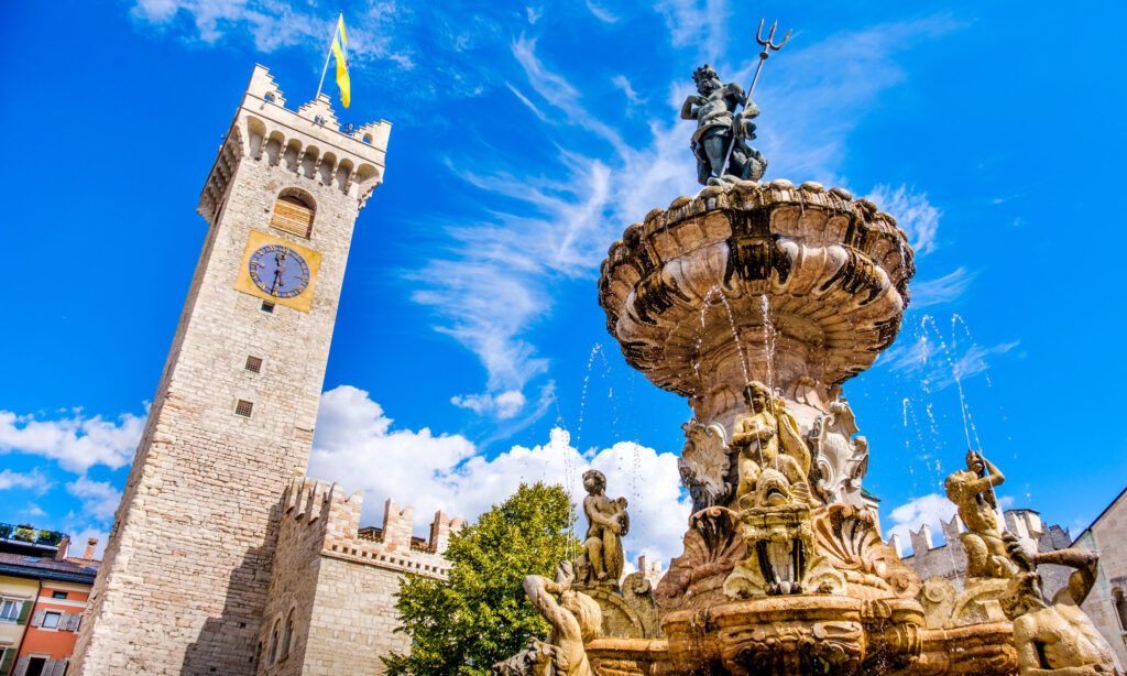 Neptune fountain in Trento and the Torre di Piazza
