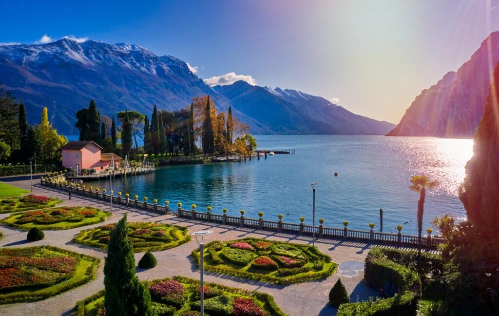 Panorama of the gorgeous Garda lake surrounded by mountains in the autumn time
