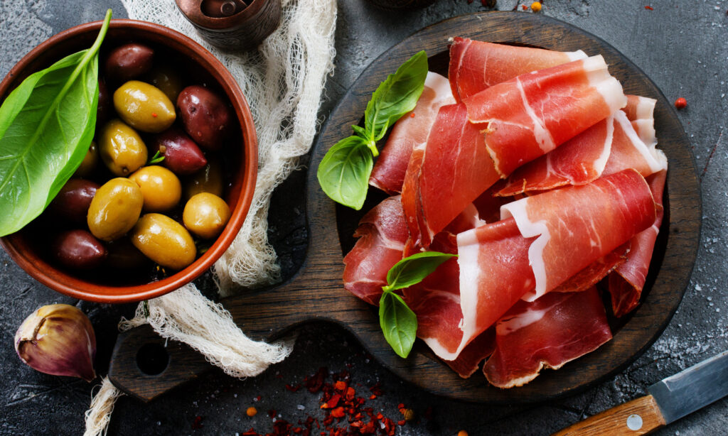 Ham and olives served as typical Italian Aperitivo