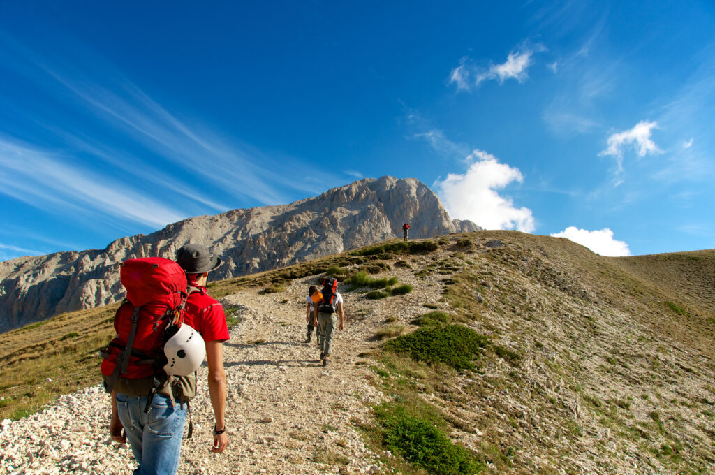 People hiking on Mountain Corno Grande Gran Sasso in the Aquila, the Italian region Abruzo
