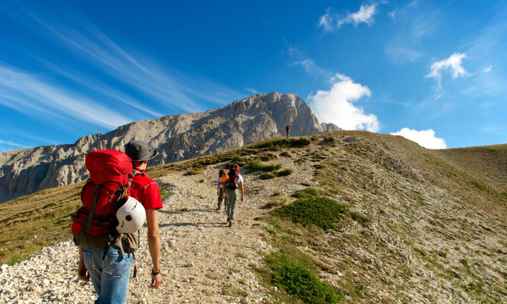 People hiking on Mountain Corno Grande Gran Sasso in the Aquila, the Italian region Abruzo