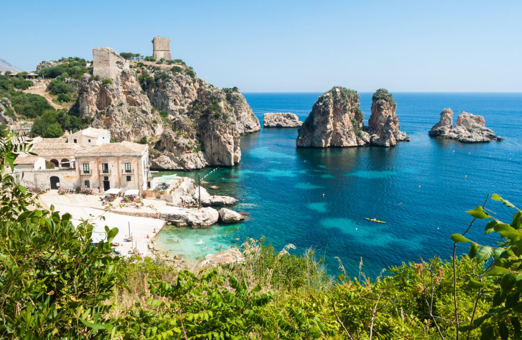 Discover Tonnara di Scopello beach on Sicily Island, its crystal-clear sea and its Faraglioni rocks