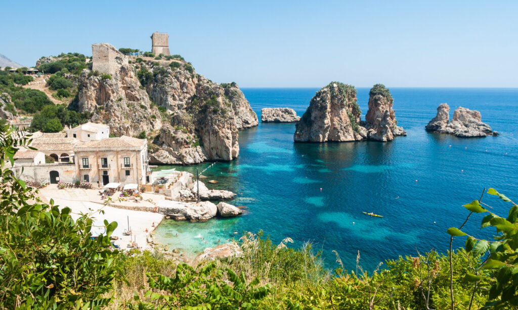 Discover Tonnara di Scopello beach on Sicily Island, its crystal-clear sea and its Faraglioni rocks