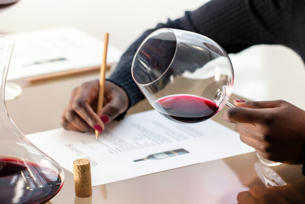 Team evaluating red wine at wine quiz