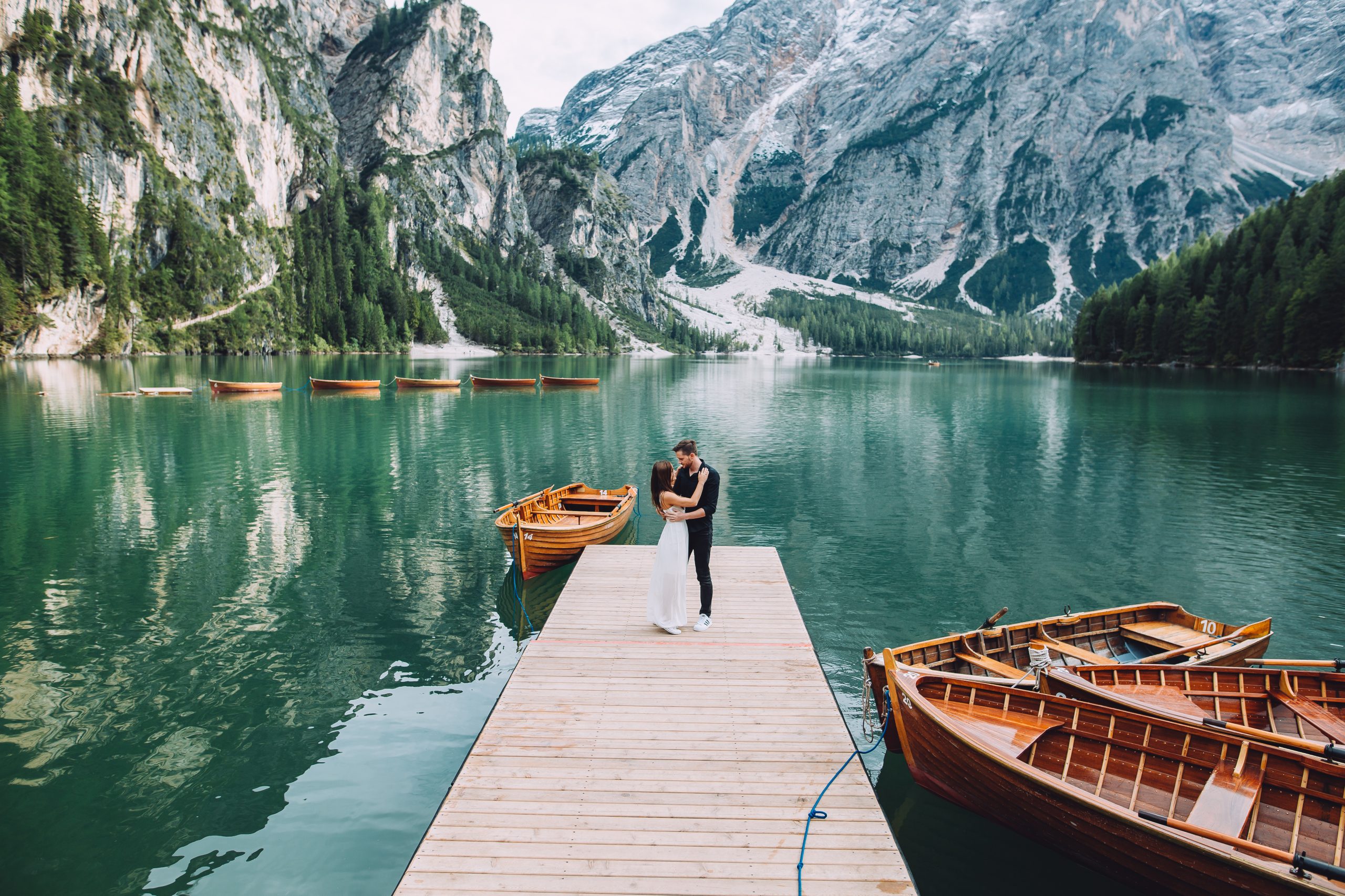 Couple near a lake in the mountains make wedding photos