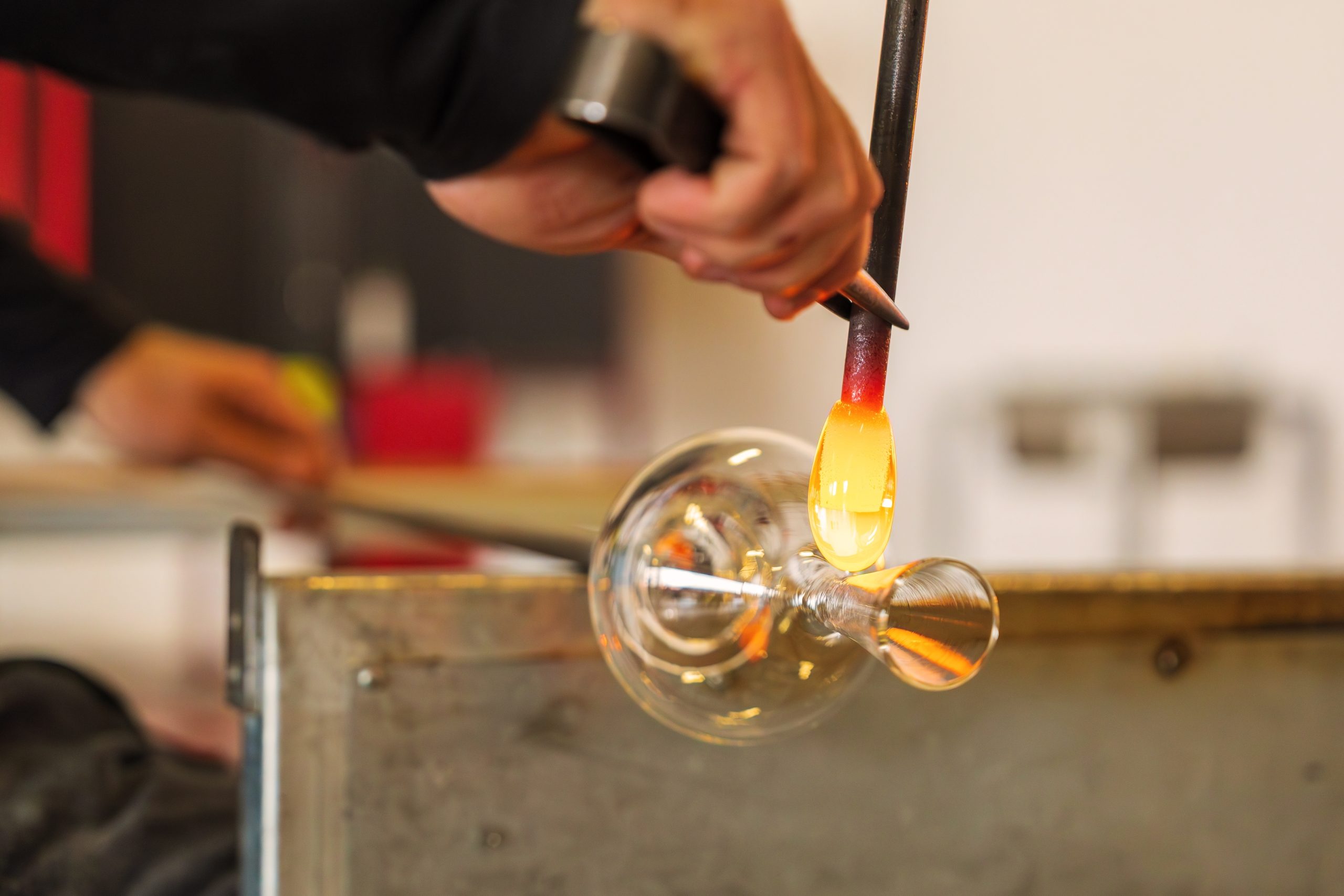 Glassblower shapping glass. 